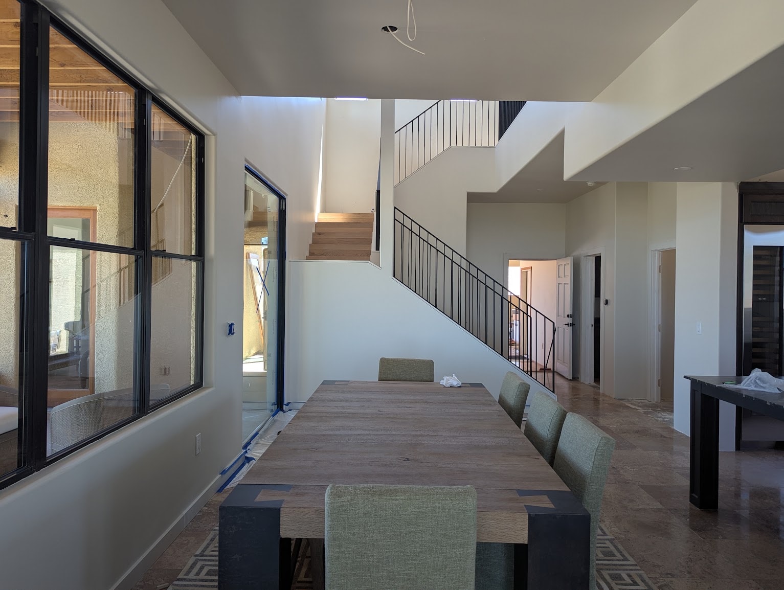 Open-concept dining room with staircase and fresh paint